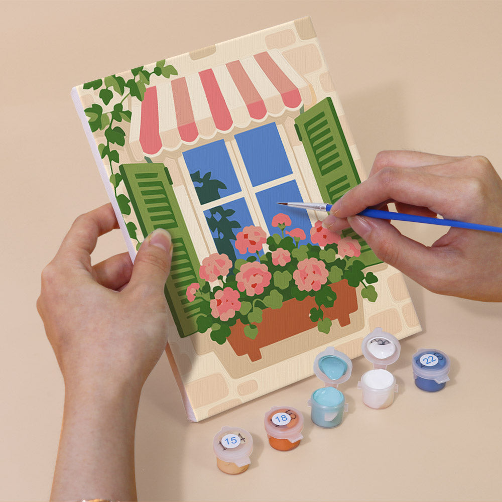 Hand holding a Flower Box Windows mini canvas while painting the details