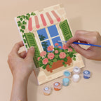 Hand holding a Flower Box Windows mini canvas while painting the details