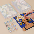 Painting one of the Flower Crowned Beauties designs next to a stack of mini canvases