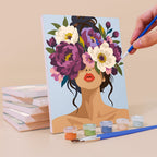 Painting a Flower Crowned Beauties mini canvas propped up beside numbered acrylic paints