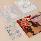 Painting one of the Flower Crowned designs next to a stack of mini canvases