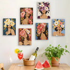 Six finished Flower Crowned mini paintings hung on a wall above a table
