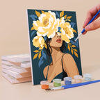 Painting a Flower Crowned mini canvas propped up beside numbered acrylic paints