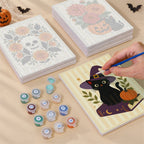 Painting one of the Folk Art Halloween designs next to a stack of mini canvases