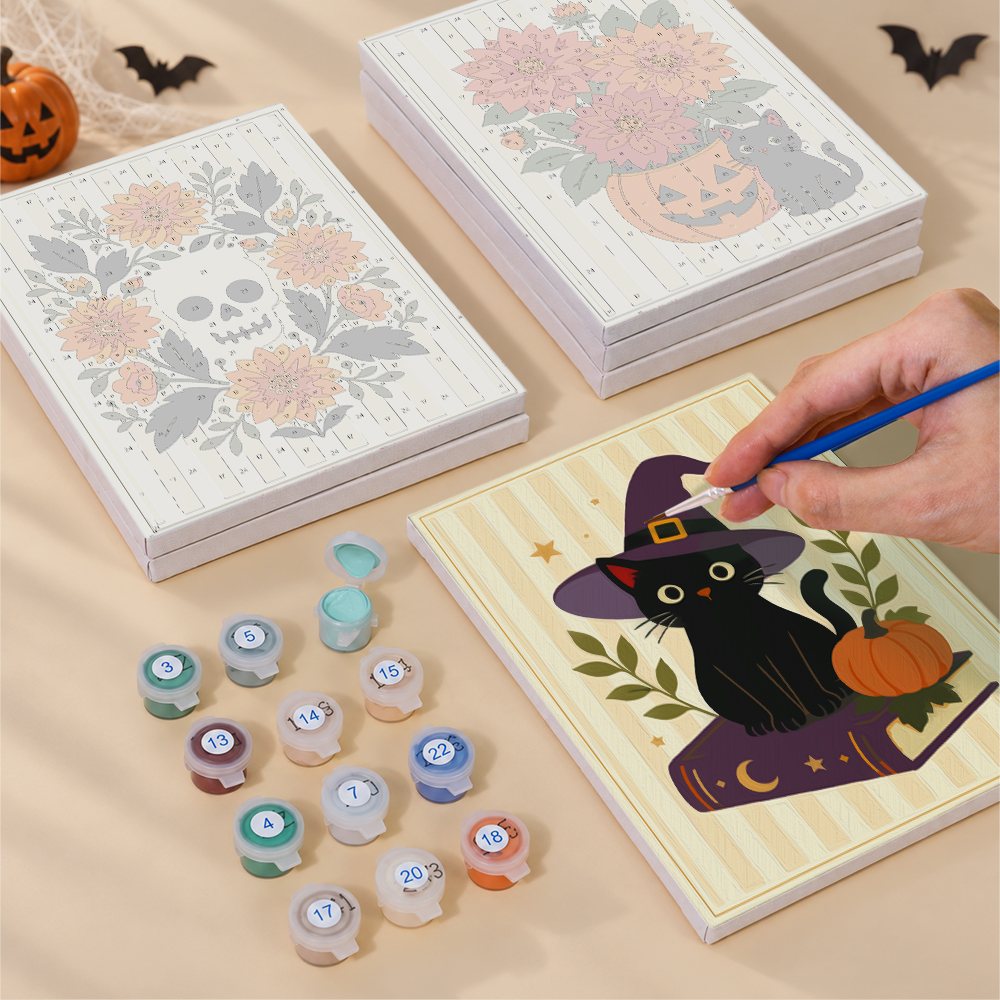 Painting one of the Folk Art Halloween designs next to a stack of mini canvases