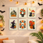 Six finished Folk Art Halloween mini paintings hung on a wall above a table