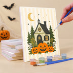 Painting a Folk Art Halloween mini canvas propped up beside numbered acrylic paints
