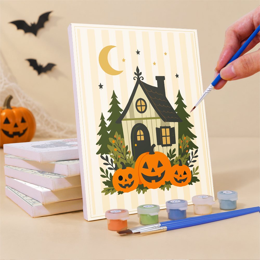 Painting a Folk Art Halloween mini canvas propped up beside numbered acrylic paints