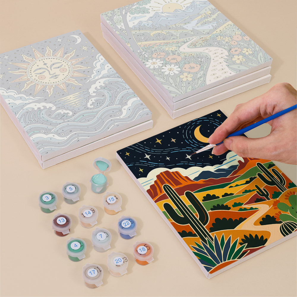 Painting one of the Folk Art Landscapes designs next to a stack of mini canvases