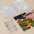 Painting one of the Folk Art Landscapes designs next to a stack of mini canvases
