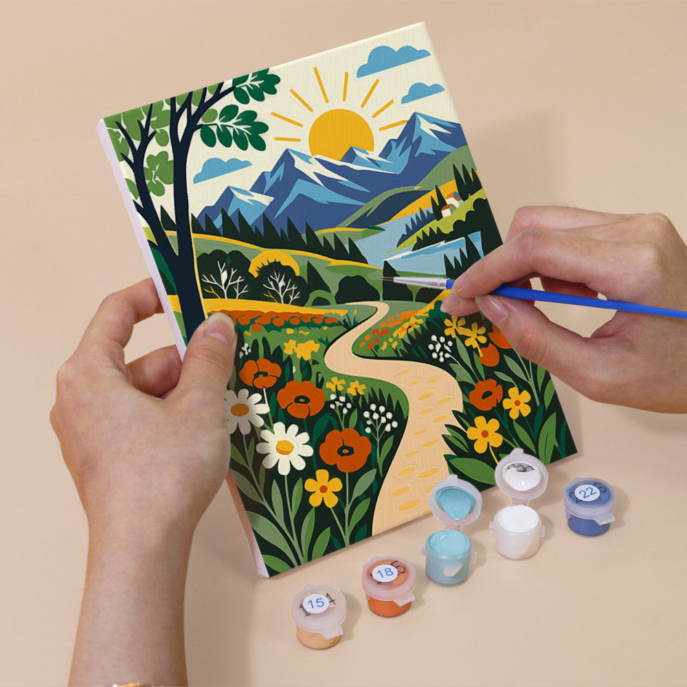 Hand holding a Folk Art Landscapes mini canvas while painting the details