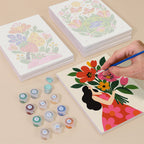 Painting one of the Folk Blossoms designs next to a stack of mini canvases