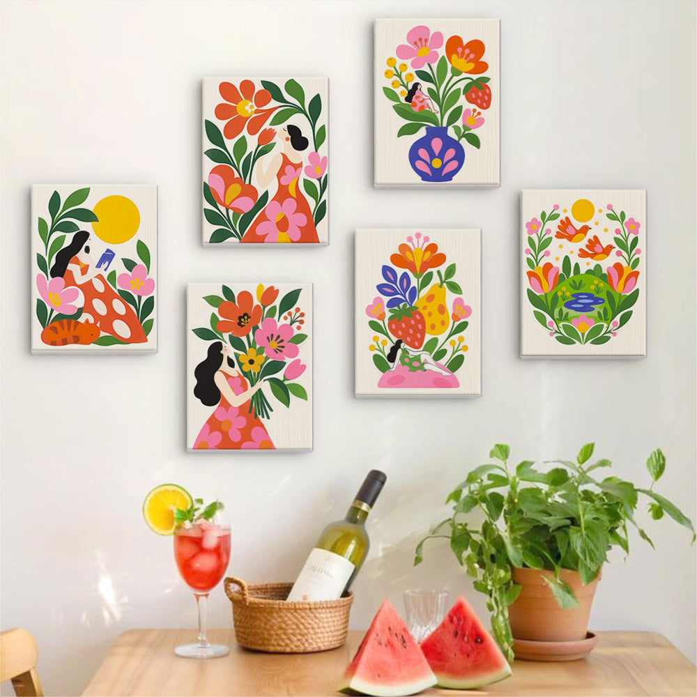 Six finished Folk Blossoms mini paintings hung on a wall above a table