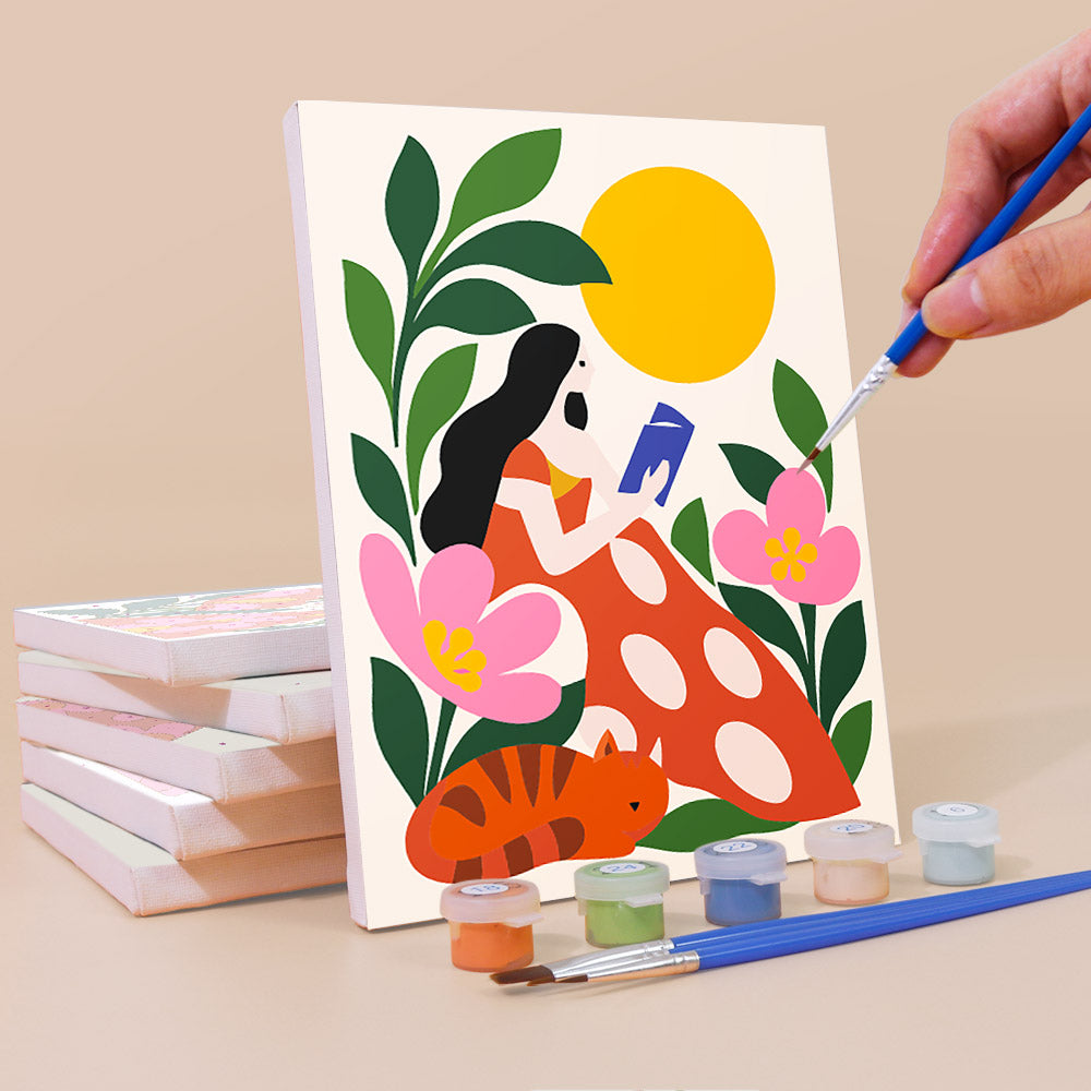 Painting a Folk Blossoms mini canvas propped up beside numbered acrylic paints