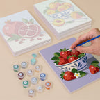 Painting one of the Fresh Fruit Bowls designs next to a stack of mini canvases