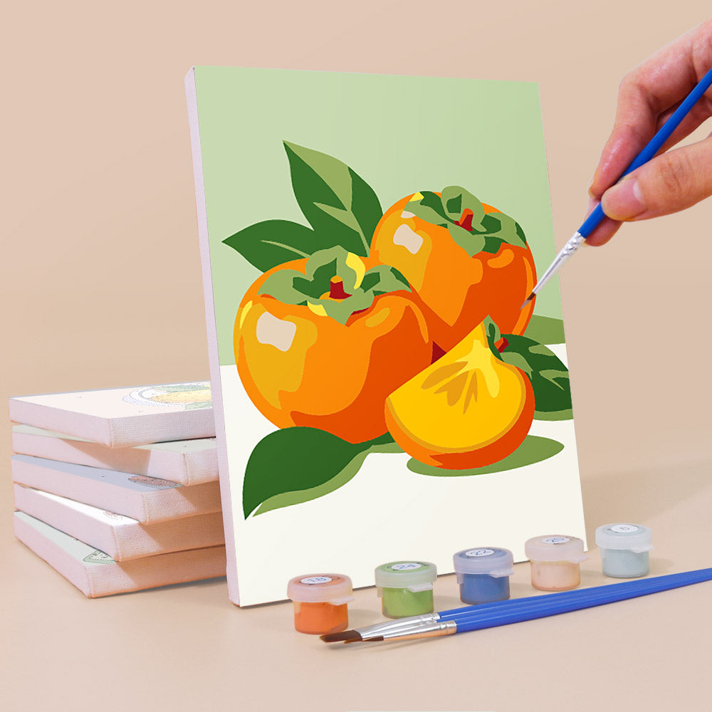 Painting a Fresh Fruit Bowls mini canvas propped up beside numbered acrylic paints