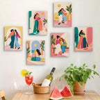 Six finished Friendship Hugs mini paintings hung on a wall above a table
