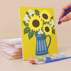 Painting a Fruit & Flower Jugs mini canvas propped up beside numbered acrylic paints