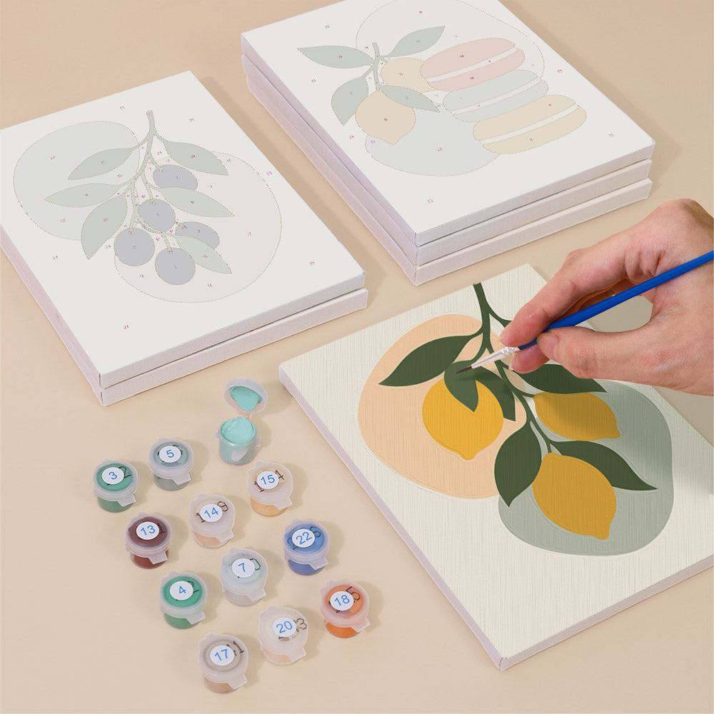 Painting one of the Fruit Branches designs next to a stack of mini canvases