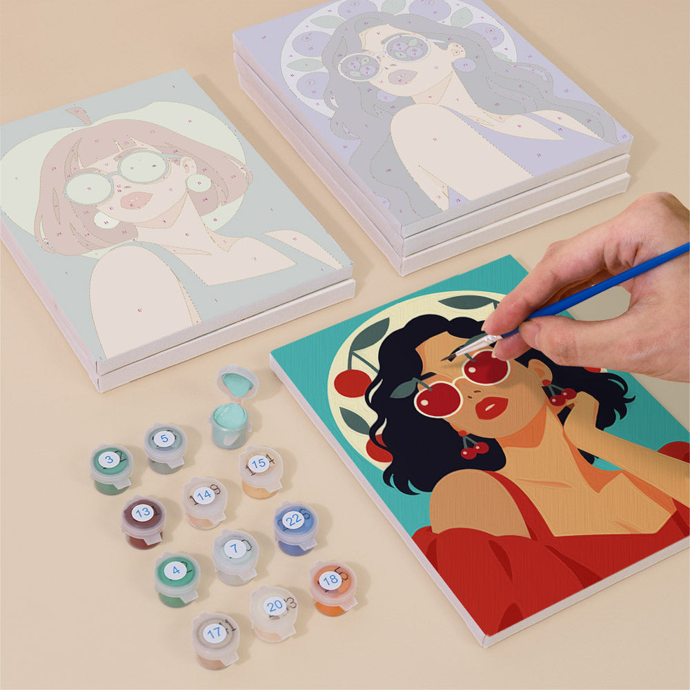 Painting one of the Fruity Shades designs next to a stack of mini canvases