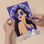Hand holding a Fruity Shades mini canvas while painting the details