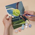 Hand holding a Game On mini canvas while painting the details
