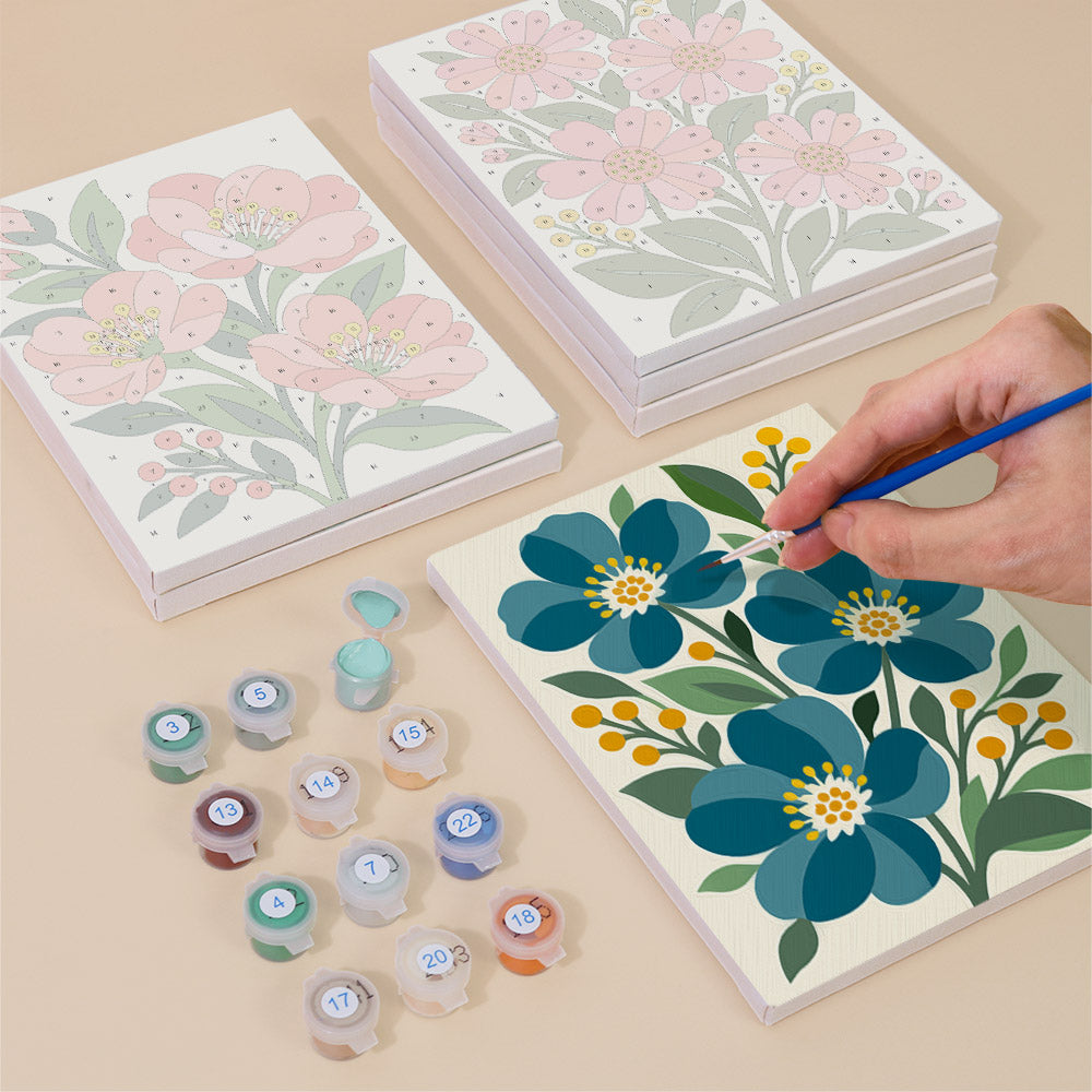 Painting one of the Garden Bouquets designs next to a stack of mini canvases