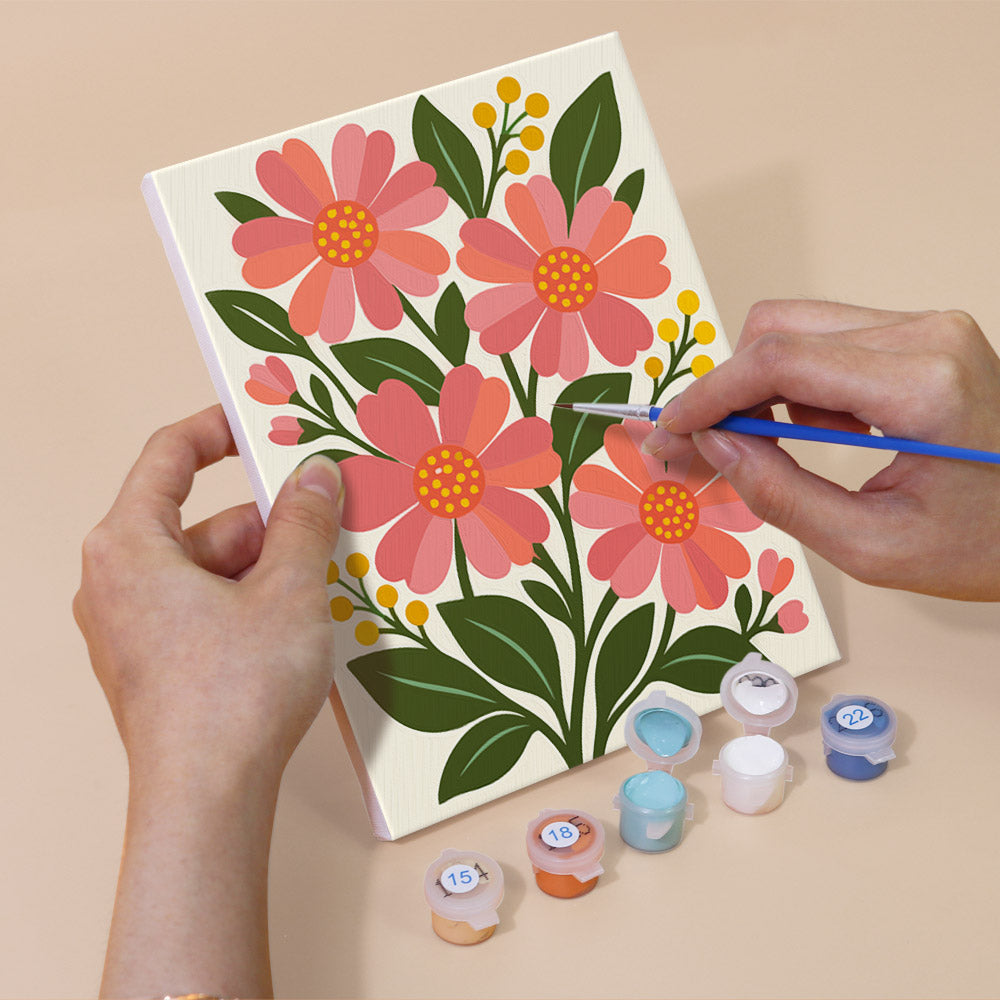 Hand holding a Garden Bouquets mini canvas while painting the details