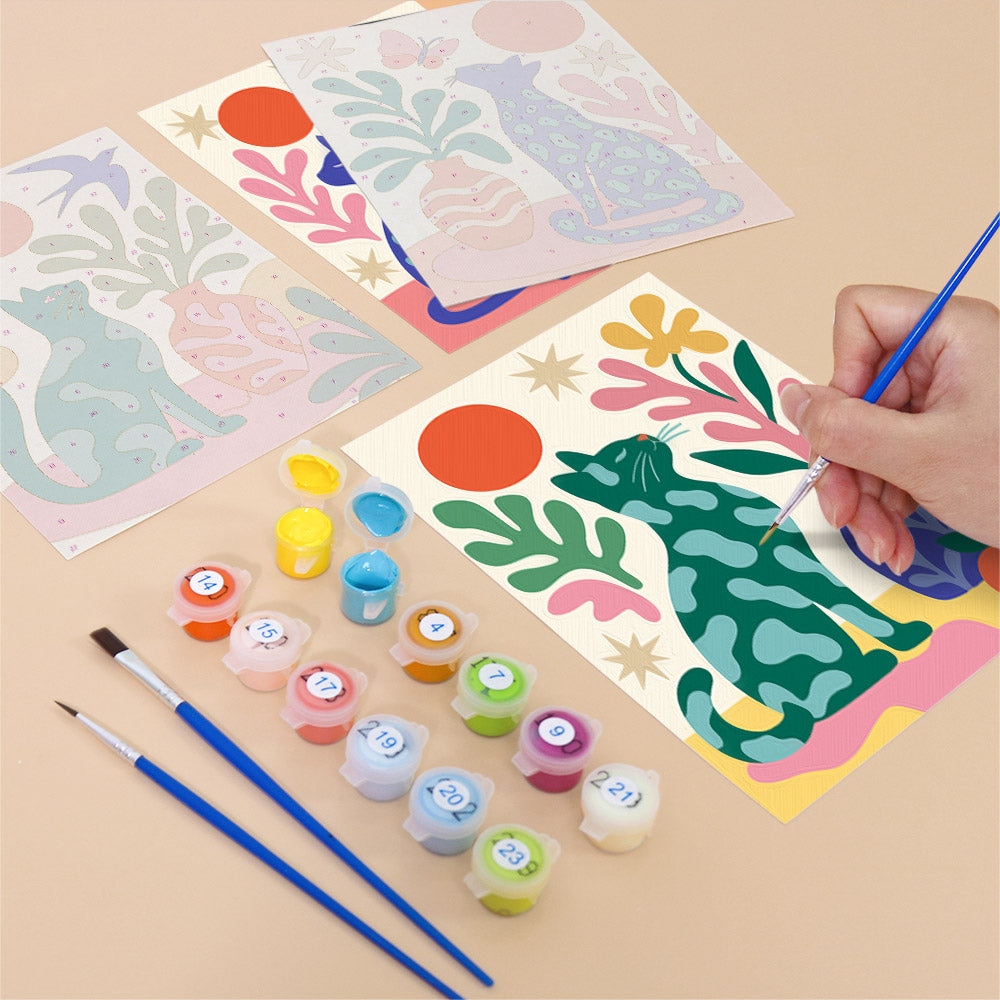 Filling in a Garden Cats mini canvas with numbered acrylic paints and a fine brush