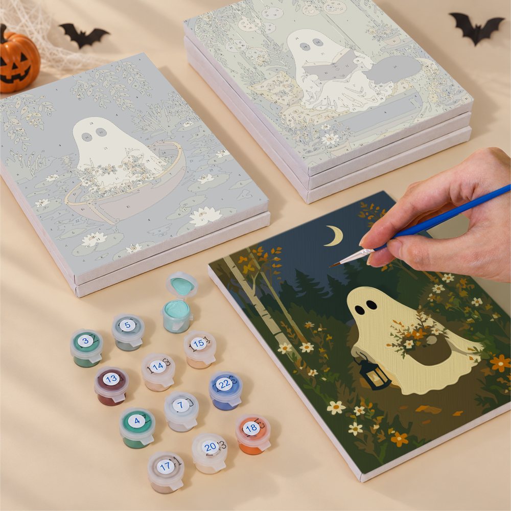 Painting one of the Garden Ghosts designs next to a stack of mini canvases