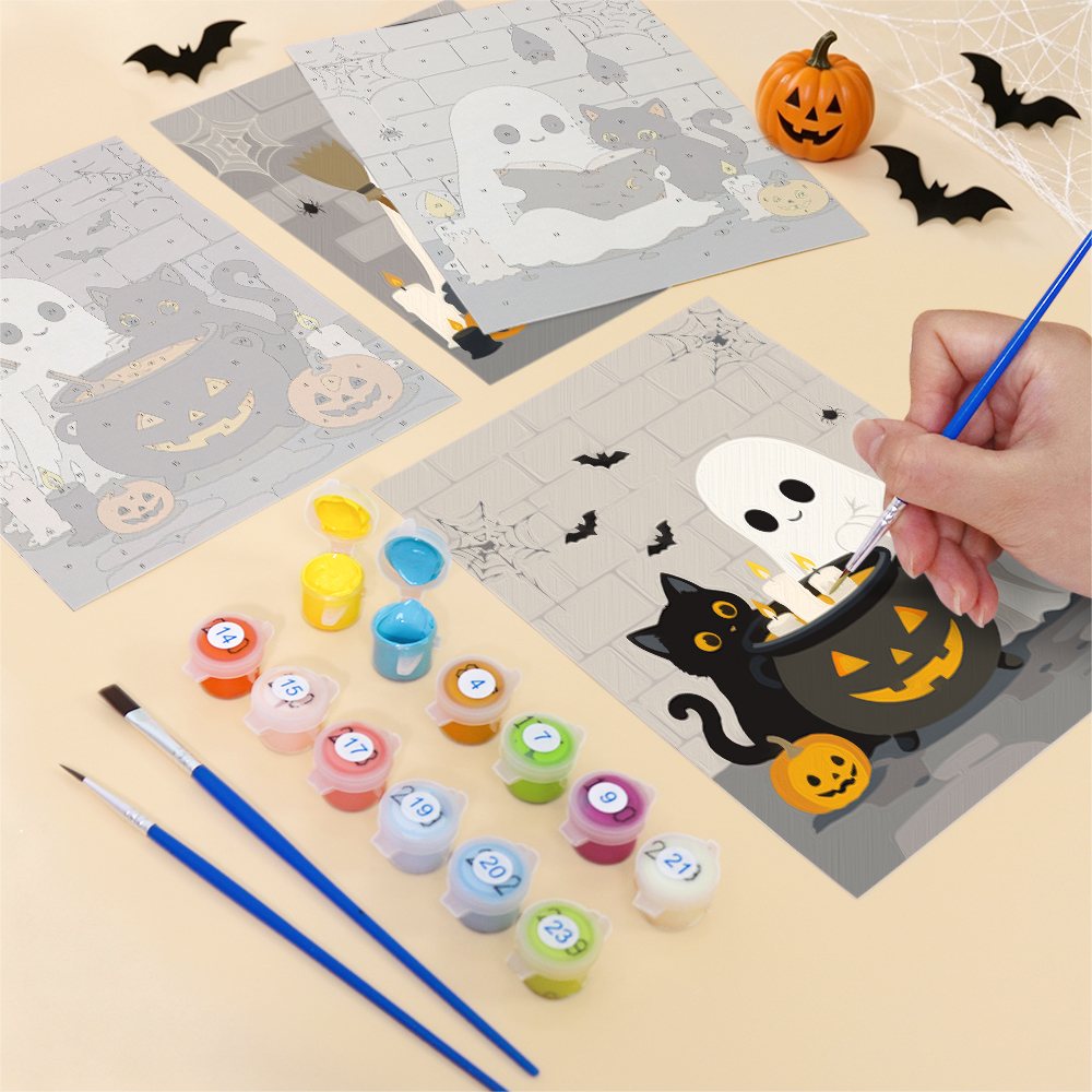 Filling in a Ghostly Cauldrons mini canvas with numbered acrylic paints and a fine brush
