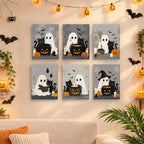 Six finished Ghostly Cauldrons mini paintings hung on a wall above a table