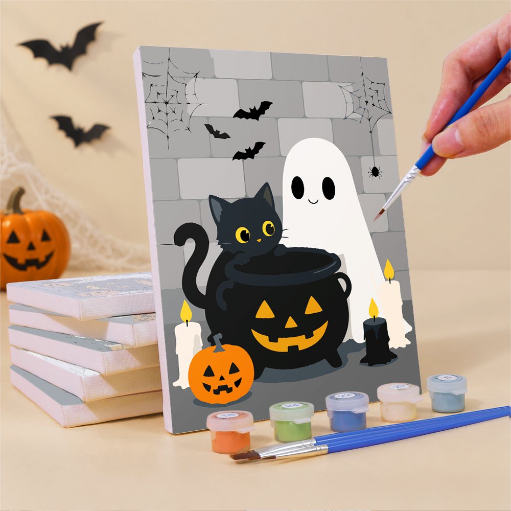 Painting a Ghostly Cauldrons mini canvas propped up beside numbered acrylic paints