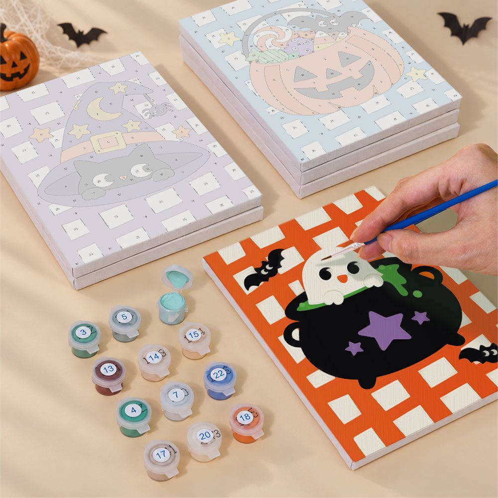 Painting one of the Gingham Halloween designs next to a stack of mini canvases