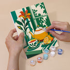 Hand holding a Golden Hour Tables mini canvas while painting the details