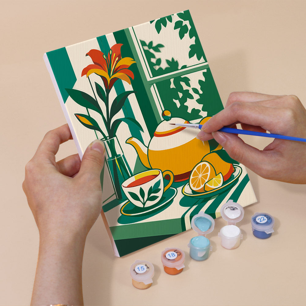 Hand holding a Golden Hour Tables mini canvas while painting the details