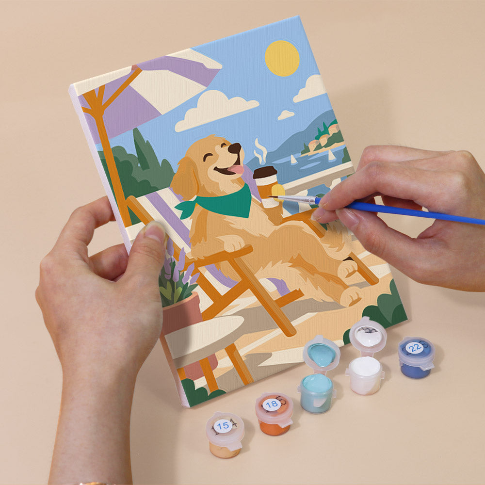 Hand holding a Golden Retriever Days mini canvas while painting the details