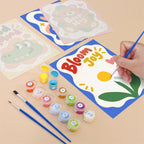 Filling in a Good Mood Club mini canvas with numbered acrylic paints and a fine brush