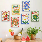 Six finished Good Mood Club mini paintings hung on a wall above a table