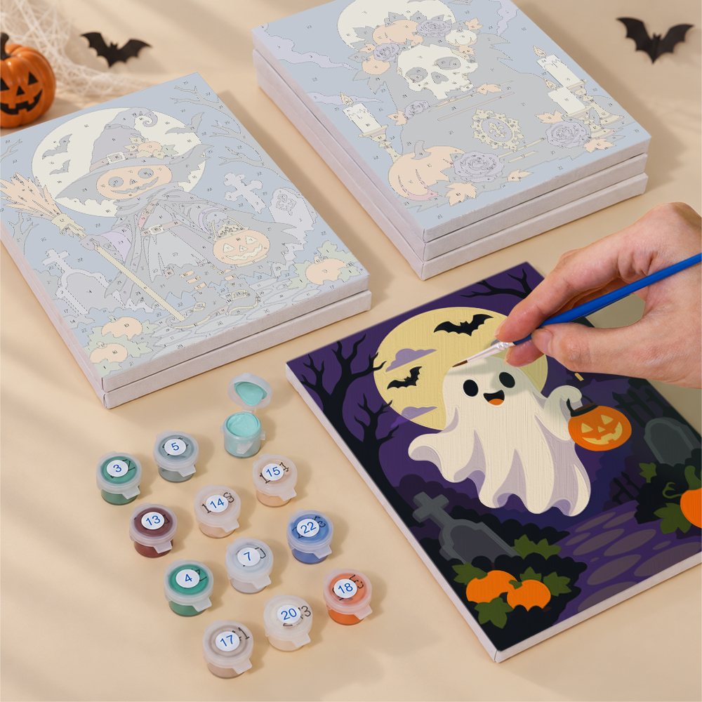 Painting one of the Gothic Graveyard Night designs next to a stack of mini canvases