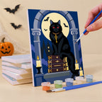 Painting a Gothic Graveyard Night mini canvas propped up beside numbered acrylic paints