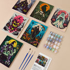 Painting one of the Gothic Nightmare Scenes designs next to a stack of mini canvases