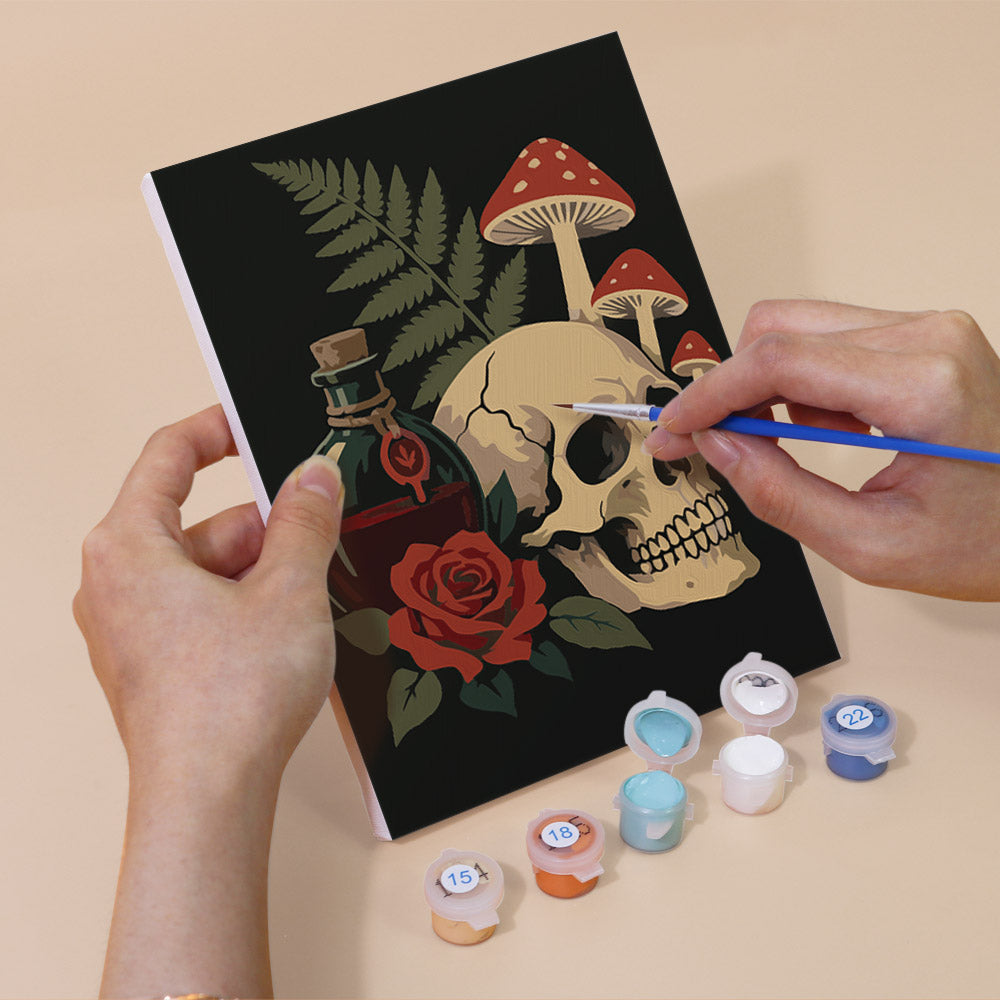 Hand holding a Gothic Still Life mini canvas while painting the details