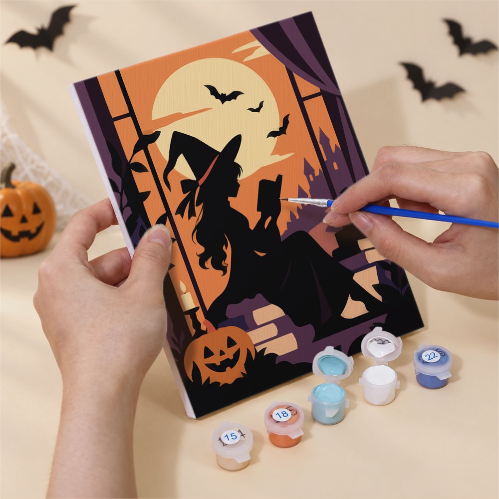 Hand holding a Gothic Twilight Tales mini canvas while painting the details