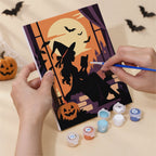Hand holding a Gothic Twilight Tales mini canvas while painting the details