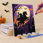 Painting a Gothic Twilight Tales mini canvas propped up beside numbered acrylic paints