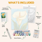 What's included in the Grace in White paint by numbers kit: numbered linen canvas, reference sheet, color guide, 24 acrylic paints, 3 brushes and thank you card