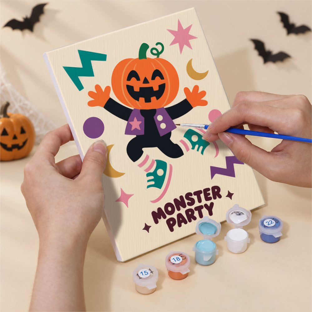 Hand holding a Groovy Monster Club mini canvas while painting the details