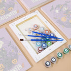 Numbered paint pots and brushes on a pre-stretched Halloween Banner Friends mini canvas