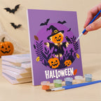 Painting a Halloween Banner Friends mini canvas propped up beside numbered acrylic paints
